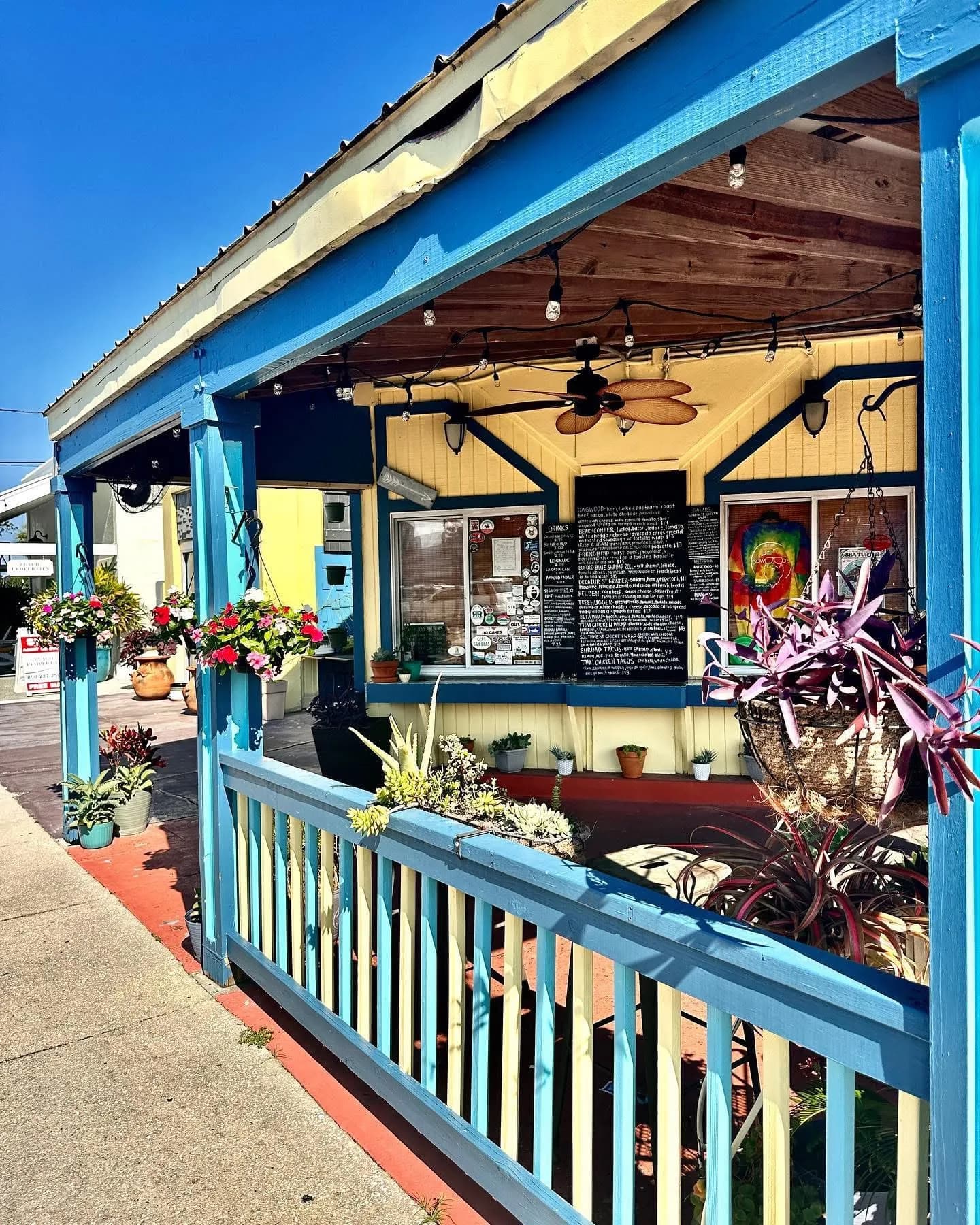 The porch, the chalkboard menu and the hanging baskets